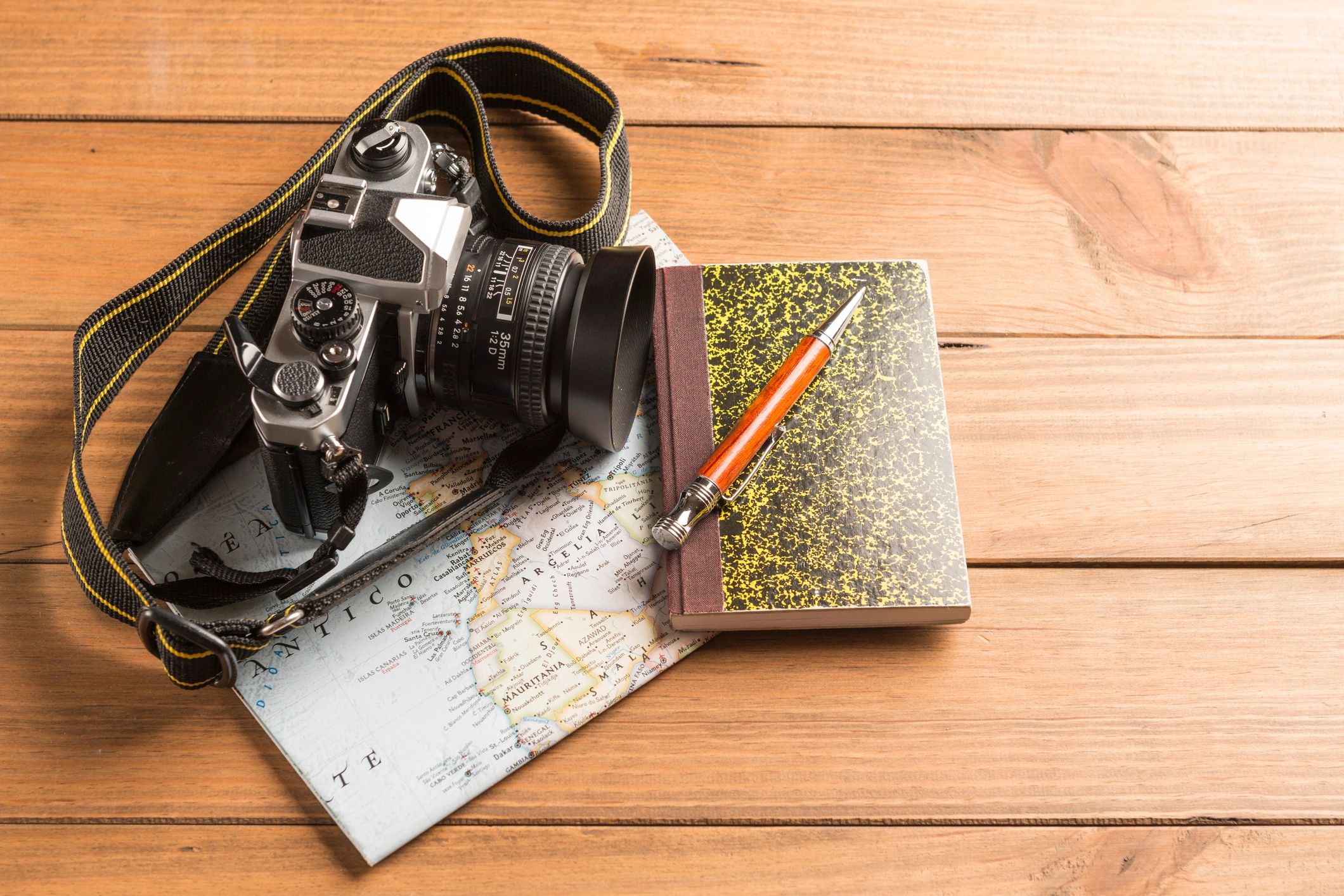 Travel concept. Camera, map, notebook and ball pen.
